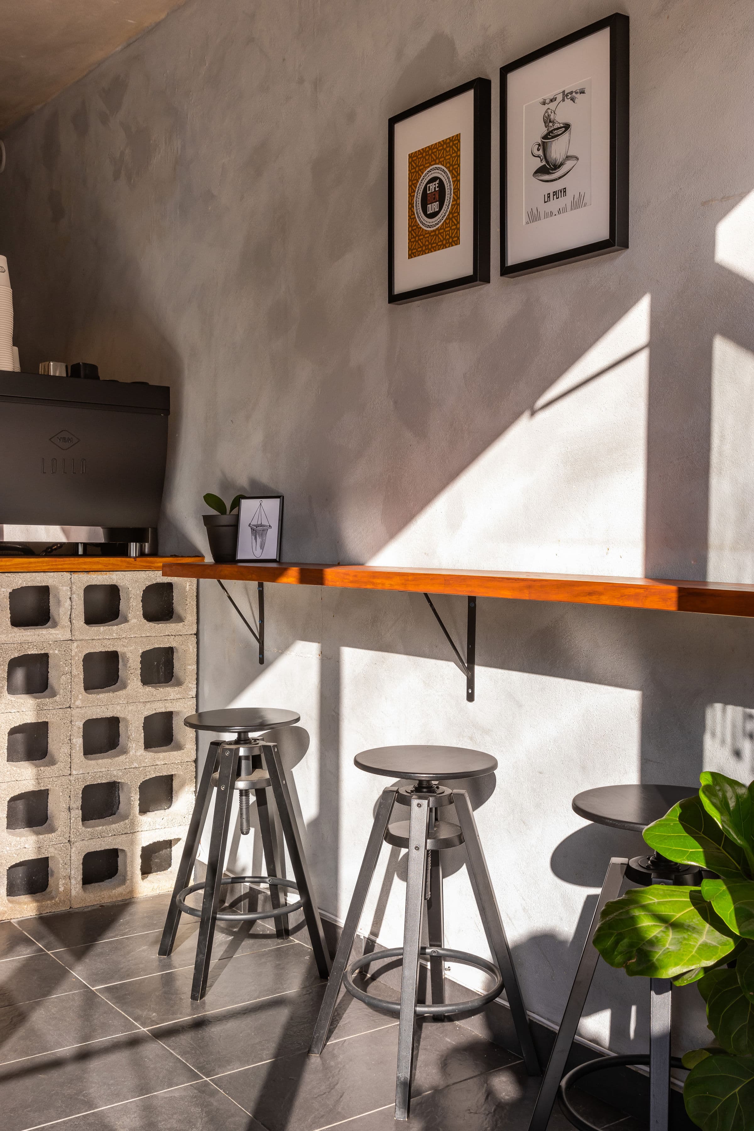 La Puya Café interior — bar seating and wall art